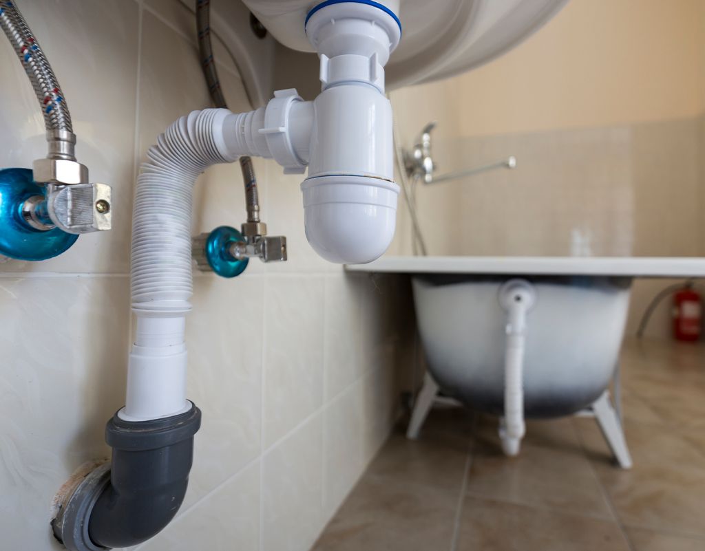 Pipework under a kitchen sink, where the stopcock is usually found after a burst pipe
